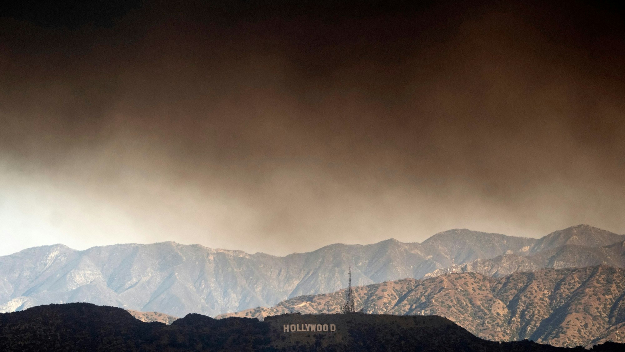 ARCHIV - Dichter Rauch von den Waldbränden zieht über das Hollywood-Zeichen.