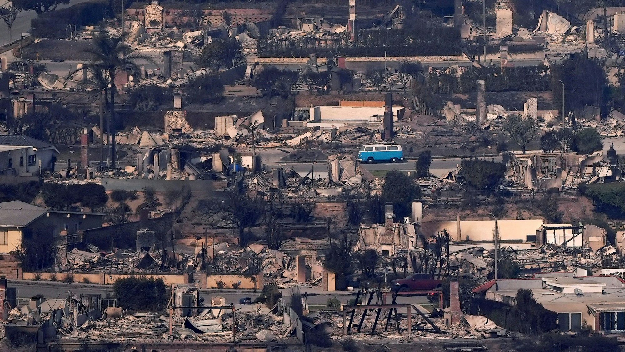 Der VW-Bulli „Azul“ steht zwischen ausgebrannten Häusern in Malibu.