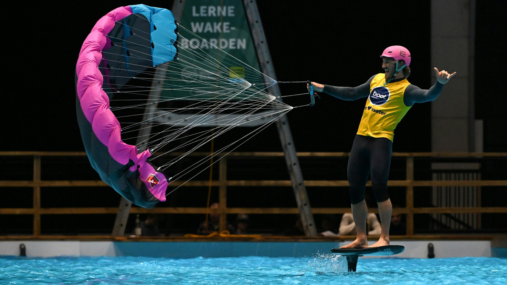 Ein Wingfoiler demonstriert einen Parawing im XXL-Becken zum Ausprobieren in Halle 17.