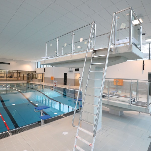Ein Drei-Meter-Sprungturm in einem Hallenbad.
