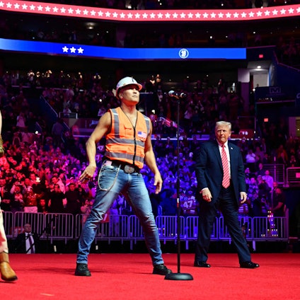 US President-elect Donald Trump looks on as the Village People perform at a MAGA victory rally at Capital One Arena in Washington, DC, on January 19, 2025, one day ahead of his inauguration ceremony. (Photo by Jim WATSON / AFP)