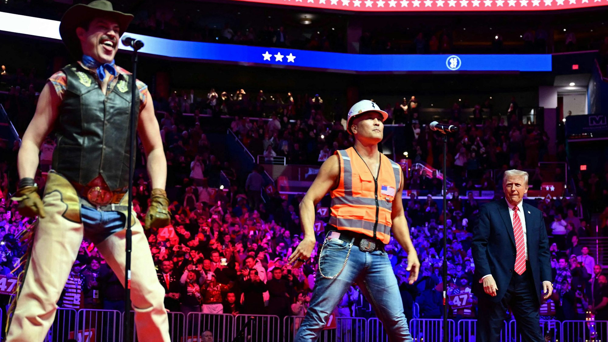 US President-elect Donald Trump looks on as the Village People perform at a MAGA victory rally at Capital One Arena in Washington, DC, on January 19, 2025, one day ahead of his inauguration ceremony. (Photo by Jim WATSON / AFP)