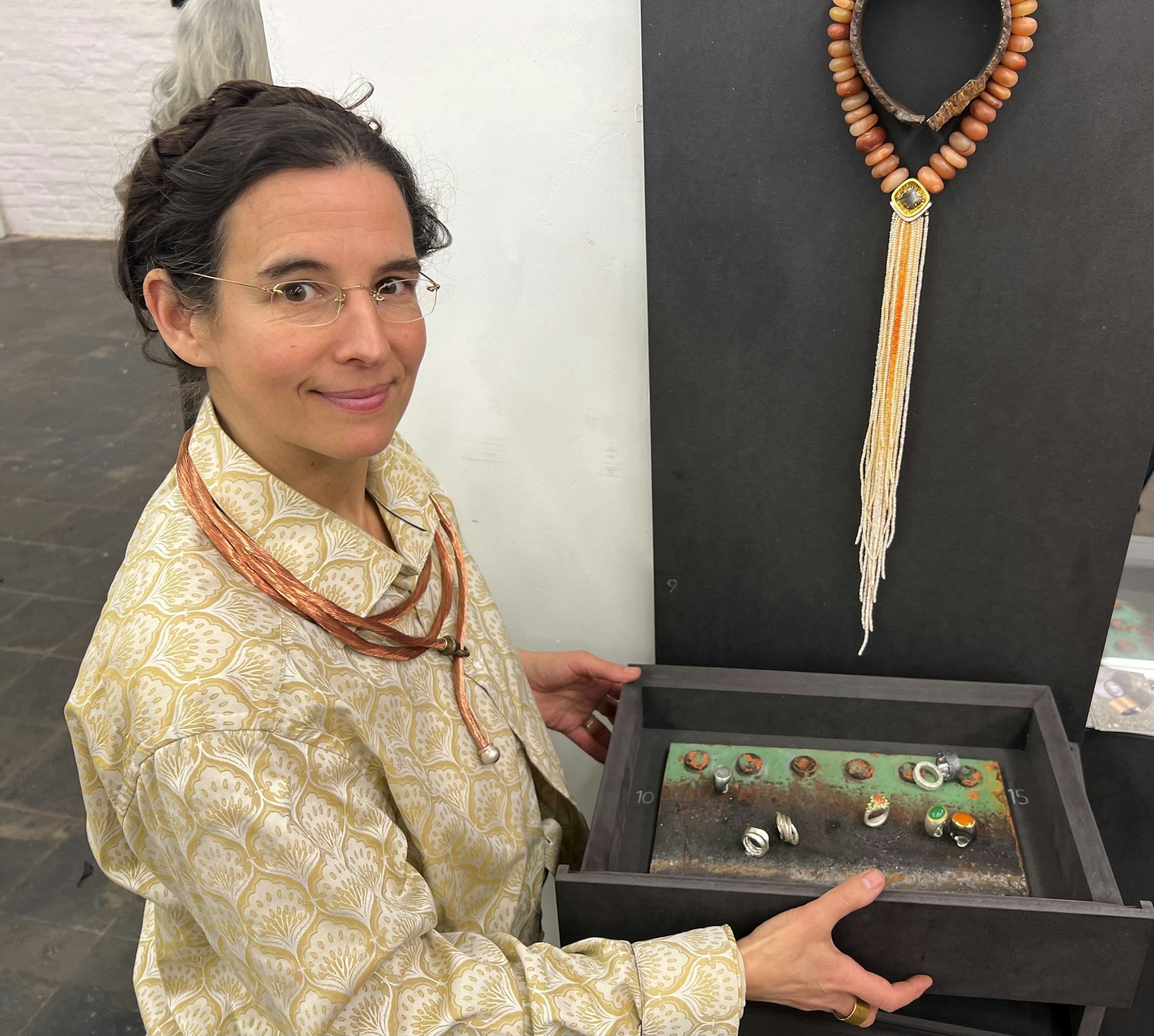 Das Foto zeigt die Künstlerin mit den ausgestellen Schmuckstücken.