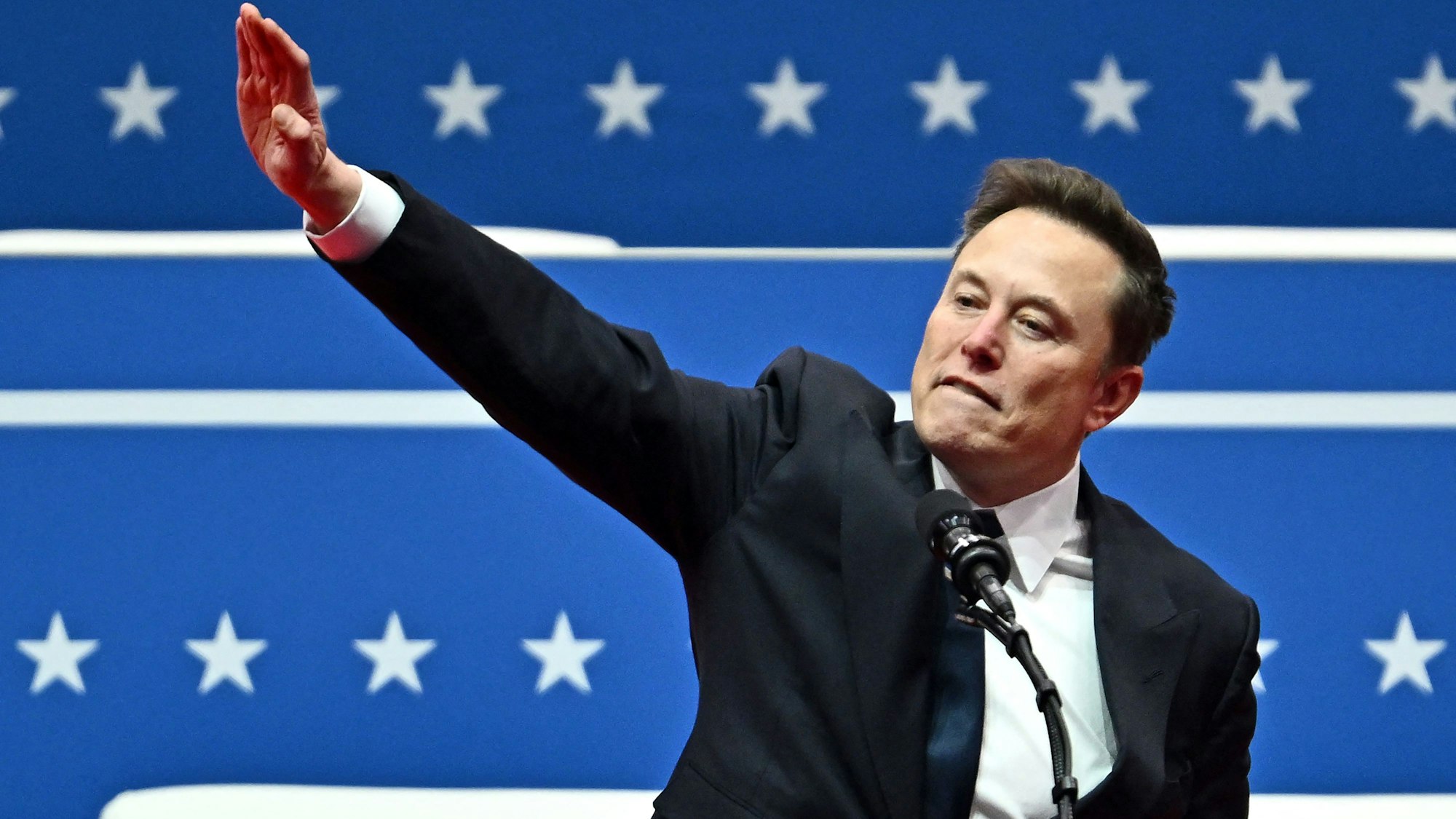 Tesla and SpaceX CEO Elon Musk gestures as he speaks during the inaugural parade inside Capitol One Arena, in Washington, DC, on January 20, 2025. (Photo by ANGELA WEISS / AFP)