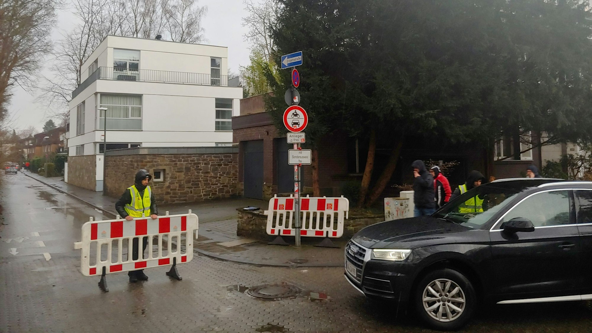 Ein Auto möchte in das Wohngebiet in Junkersdorf fahren, doch mobile Absperrungen hindern die Durchfahrt.