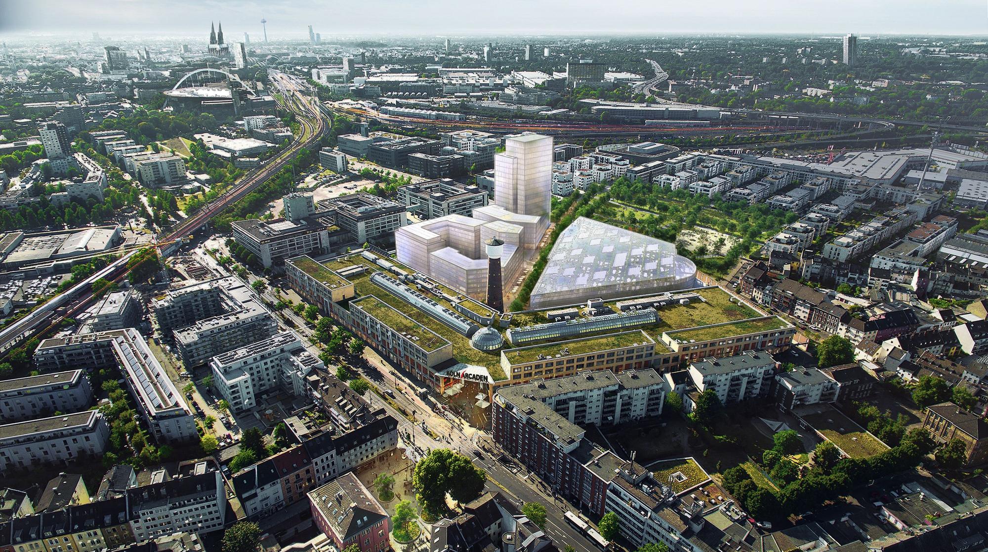 Zu sehen sind im Vordergrund die Köln Arcaden, im Hintergrund ragt ein Neubaumodell mit einem markanten Hochhaus empor.