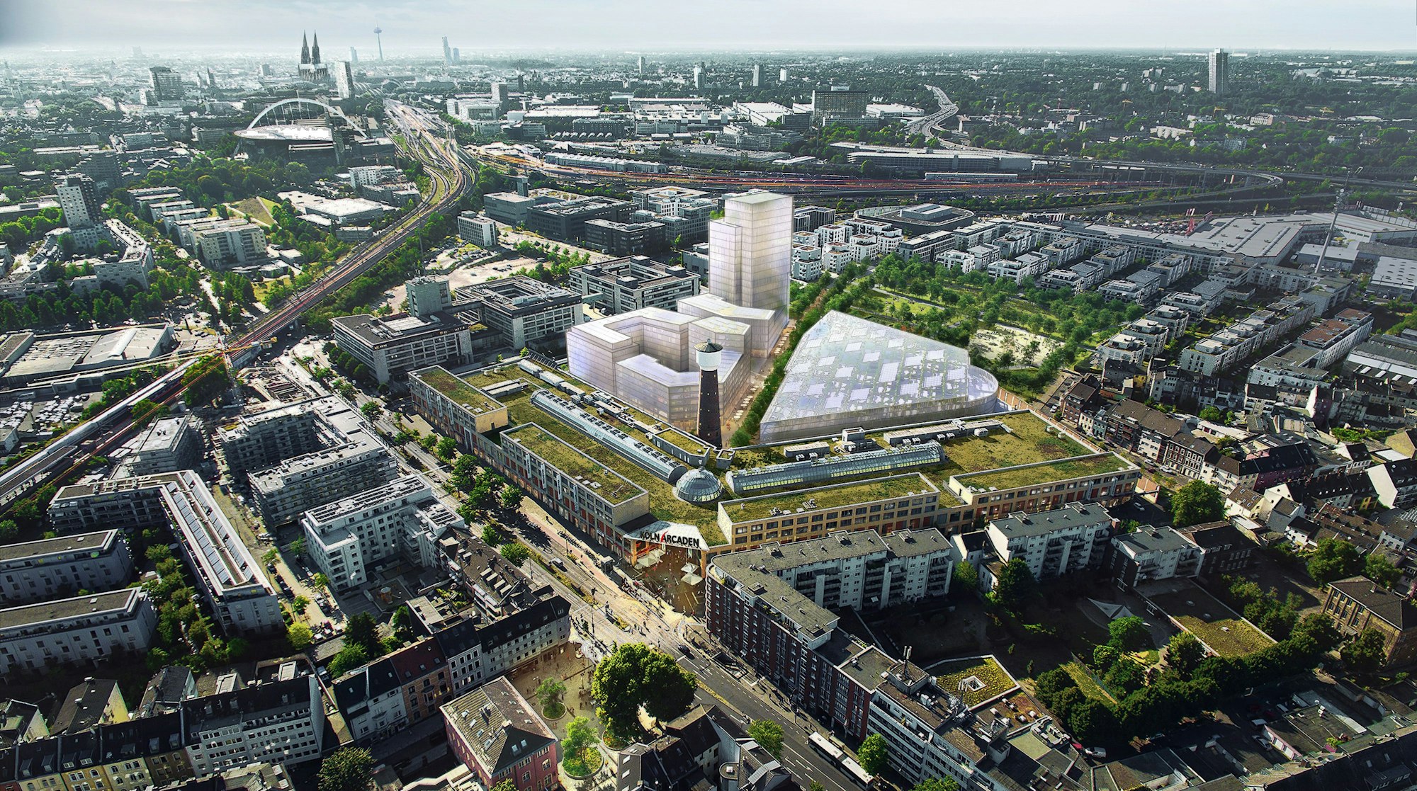 Zu sehen sind im Vordergrund die Köln Arcaden, im Hintergrund ragt ein Neubaumodell mit einem markanten Hochhaus empor.