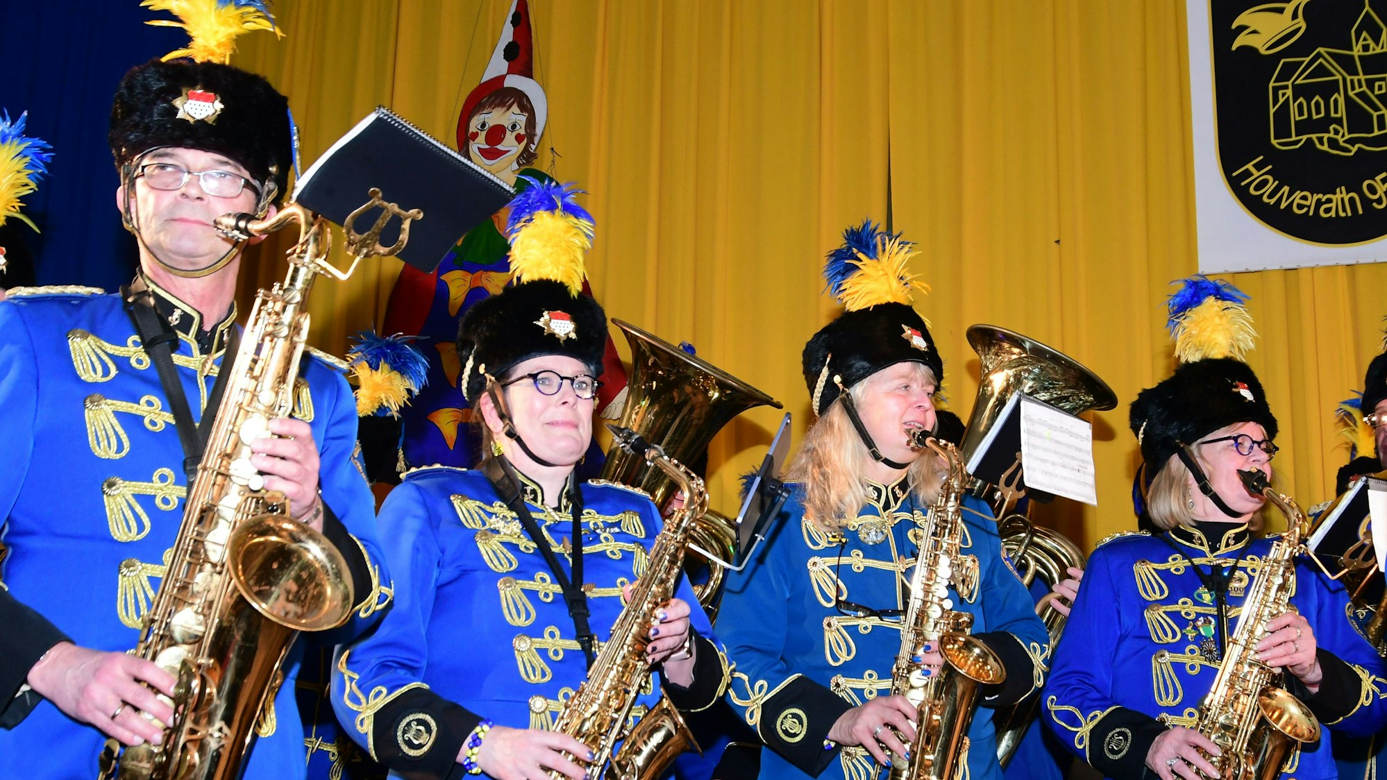 Das Bild zeigt Musikerinnen und Musiker in blauen Uniformen mit Blasinstrumenten.