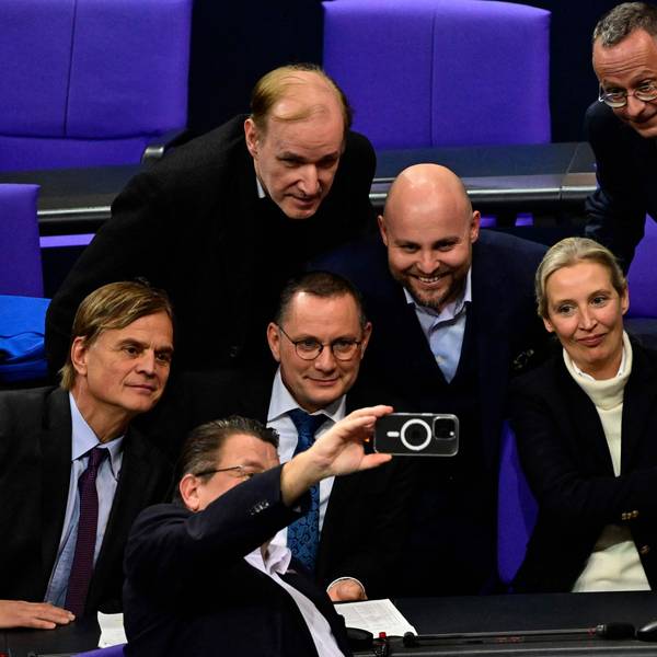 Members of the far-right Alternative for Germany (AfD) party including AfD co-leaders Alice Weidel (2ndR) and Tino Chrupalla (2ndL) take a group picture with a mobile phone as they celebrate after a vote during a session at the Bundestag, lower house of parliament, on January 29, 2025 in Berlin. (Photo by John MACDOUGALL / AFP)