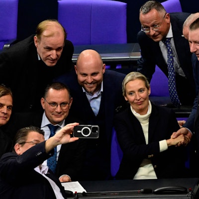 Members of the far-right Alternative for Germany (AfD) party including AfD co-leaders Alice Weidel (2ndR) and Tino Chrupalla (2ndL) take a group picture with a mobile phone as they celebrate after a vote during a session at the Bundestag, lower house of parliament, on January 29, 2025 in Berlin. (Photo by John MACDOUGALL / AFP)