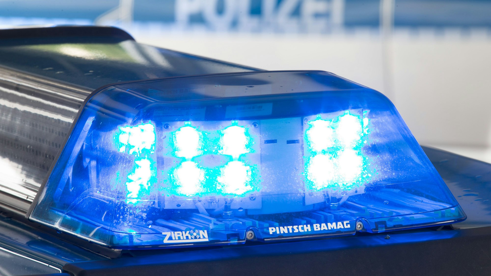 Ein Blaulicht leuchtet auf dem Dach eines Polizeiwagens.