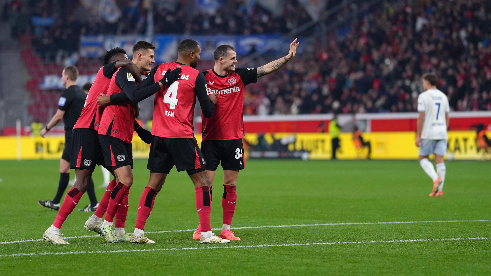 Bayer Leverkusen's Czech forward #14 Patrik Schick (3rd L) is celebrated by team mates after scoring the 3-0 goal during the German first division Bundesliga football match Bayer 04 Leverkusen v TSG 1899 Hoffenheim in Leverkusen, western Germany on February 2, 2025. (Photo by Pau BARRENA / AFP) / DFL REGULATIONS PROHIBIT ANY USE OF PHOTOGRAPHS AS IMAGE SEQUENCES AND/OR QUASI-VIDEO