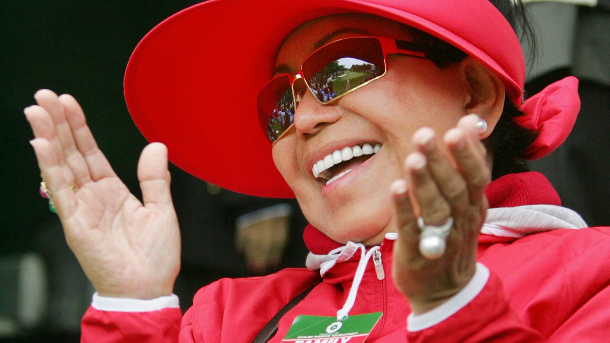 (FILES) Mother of Tiger Woods, Kutilda Punsawad Woods, claps her hands to celebrate his son's victory after playfoff during the final round of the Dunlop Phoenix Tournament at the Phoenix Country Club in Miyazaki, southern Japan, 20 November 2005. Tiger Woods announced on February 4, 2025 that his mother Kutilda had passed away, paying tribute to his parent as "my biggest fan." (Photo by Kazuhiro NOGI / AFP)