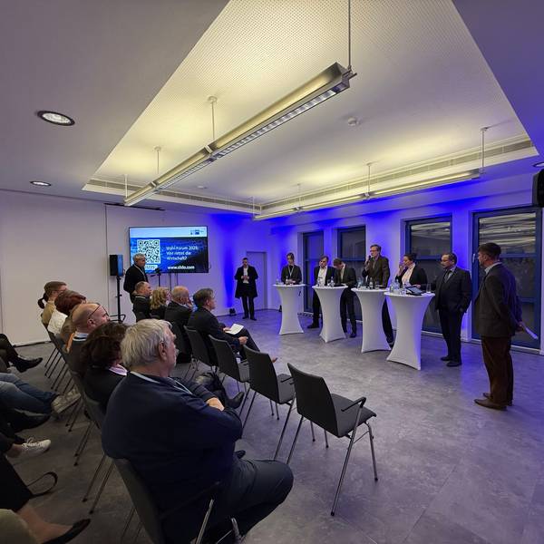 Nyke Slawik, Tomás Santillán, Karl Lauterbach, Rolf Albach, Caroline Bosbach und Harald Weyel stehen an Tischen in der Opladener IHK