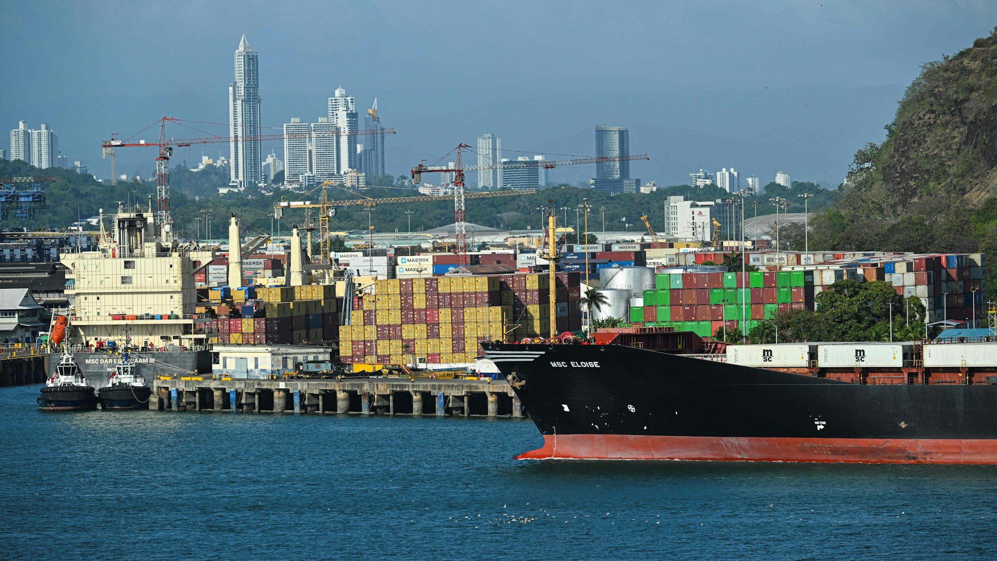 A cargo ship waits at Balboa port before crossing the Panama Canal in Panama City on February 4,2025. Two Panamanian lawyers filed a complaint Monday to cancel the concession of a Hong Kong-based company for operating two ports on the Panama Canal, following US President Donald Trump's threats to seize the vital waterway. (Photo by Martin BERNETTI / AFP)