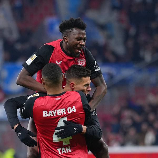 Bayer Leverkusen's Czech forward #14 Patrik Schick (C) is celebrated by team mates Bayer Leverkusen's German defender #04 Jonathan Tah (front) and Bayer Leverkusen's Burkinabe defender #12 Edmond Tapsoba (top) after scoring the 3-0 goal during the German first division Bundesliga football match Bayer 04 Leverkusen v TSG 1899 Hoffenheim in Leverkusen, western Germany on February 2, 2025. (Photo by Pau BARRENA / AFP) / DFL REGULATIONS PROHIBIT ANY USE OF PHOTOGRAPHS AS IMAGE SEQUENCES AND/OR QUASI-VIDEO