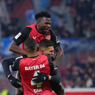 Bayer Leverkusen's Czech forward #14 Patrik Schick (C) is celebrated by team mates Bayer Leverkusen's German defender #04 Jonathan Tah (front) and Bayer Leverkusen's Burkinabe defender #12 Edmond Tapsoba (top) after scoring the 3-0 goal during the German first division Bundesliga football match Bayer 04 Leverkusen v TSG 1899 Hoffenheim in Leverkusen, western Germany on February 2, 2025. (Photo by Pau BARRENA / AFP) / DFL REGULATIONS PROHIBIT ANY USE OF PHOTOGRAPHS AS IMAGE SEQUENCES AND/OR QUASI-VIDEO