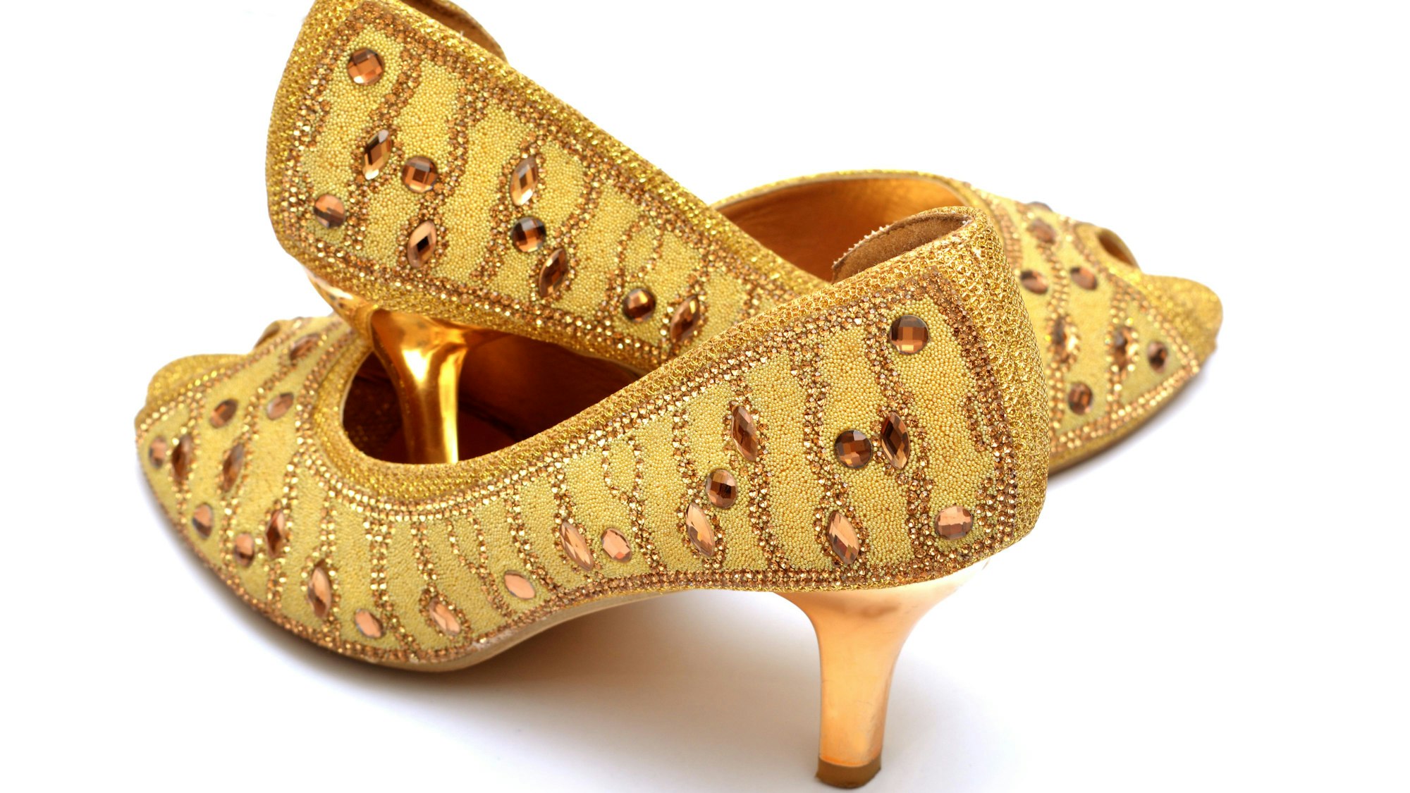 Golden lady shoes closeup isolated.