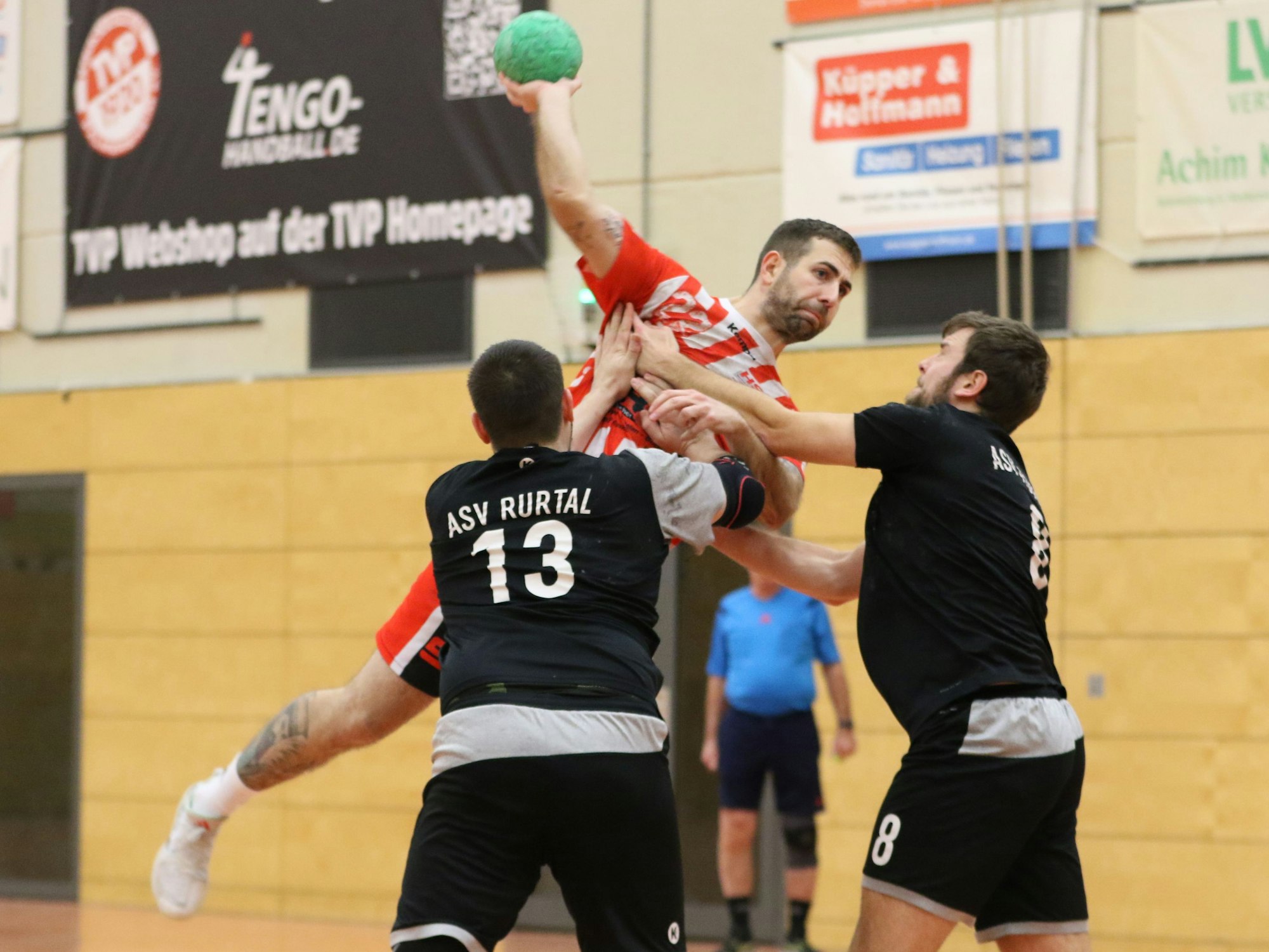 Euskirchens Kapitän David Henzel steigt zum Wurf hoch, zwei Gegner versuchen ihn zu stören.