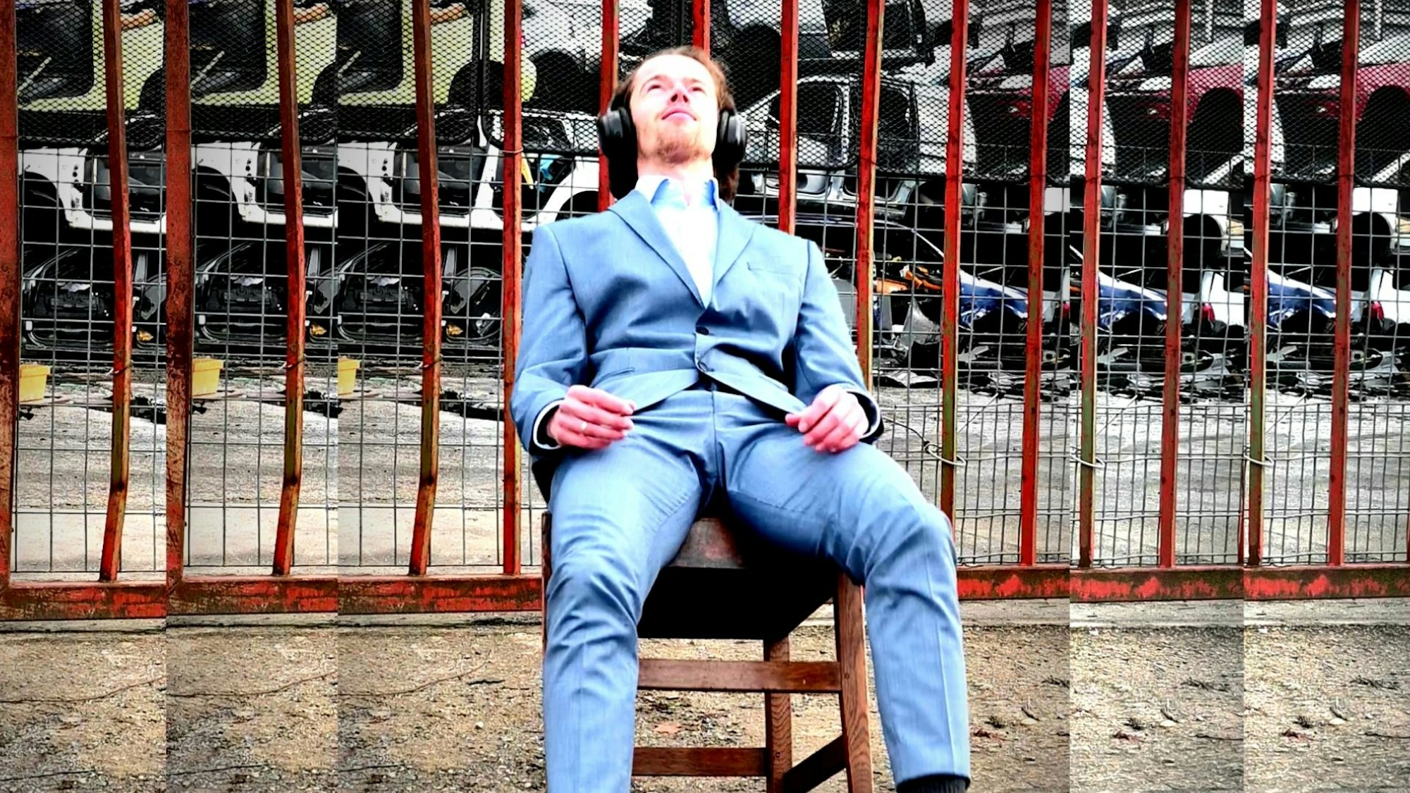 Ein Mann sitzt auf einem Stuhl und kippt damit nach hinten.