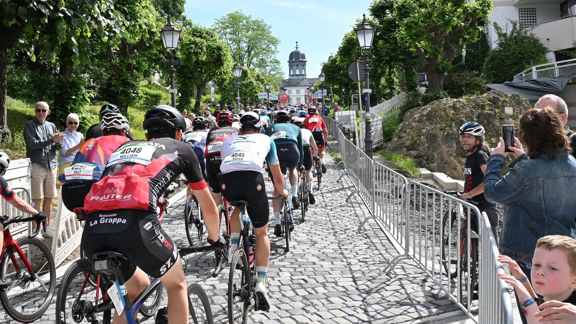 Radrennfahrer fahren den Schlossberg hinauf.