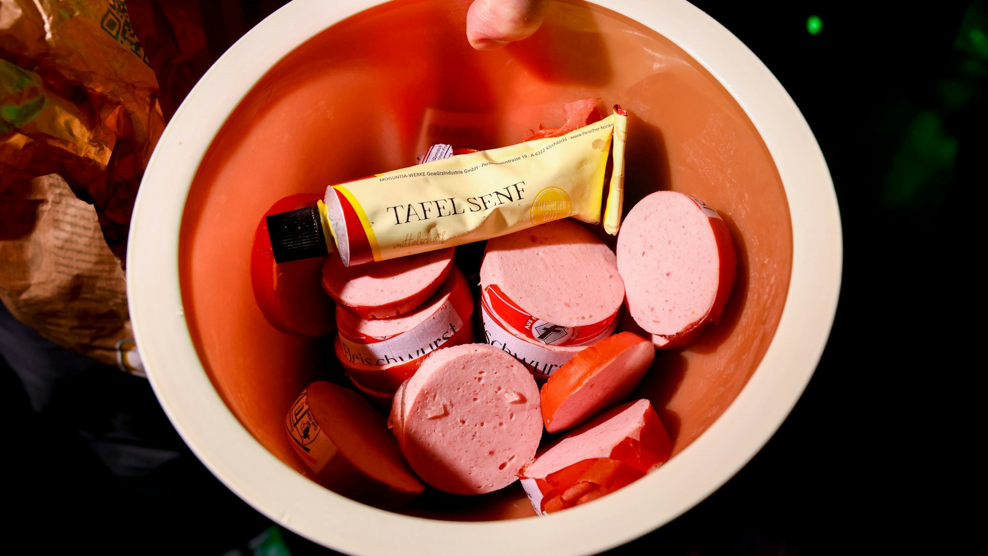 Fleischwurst und Senf in einer Tupperschüssel.