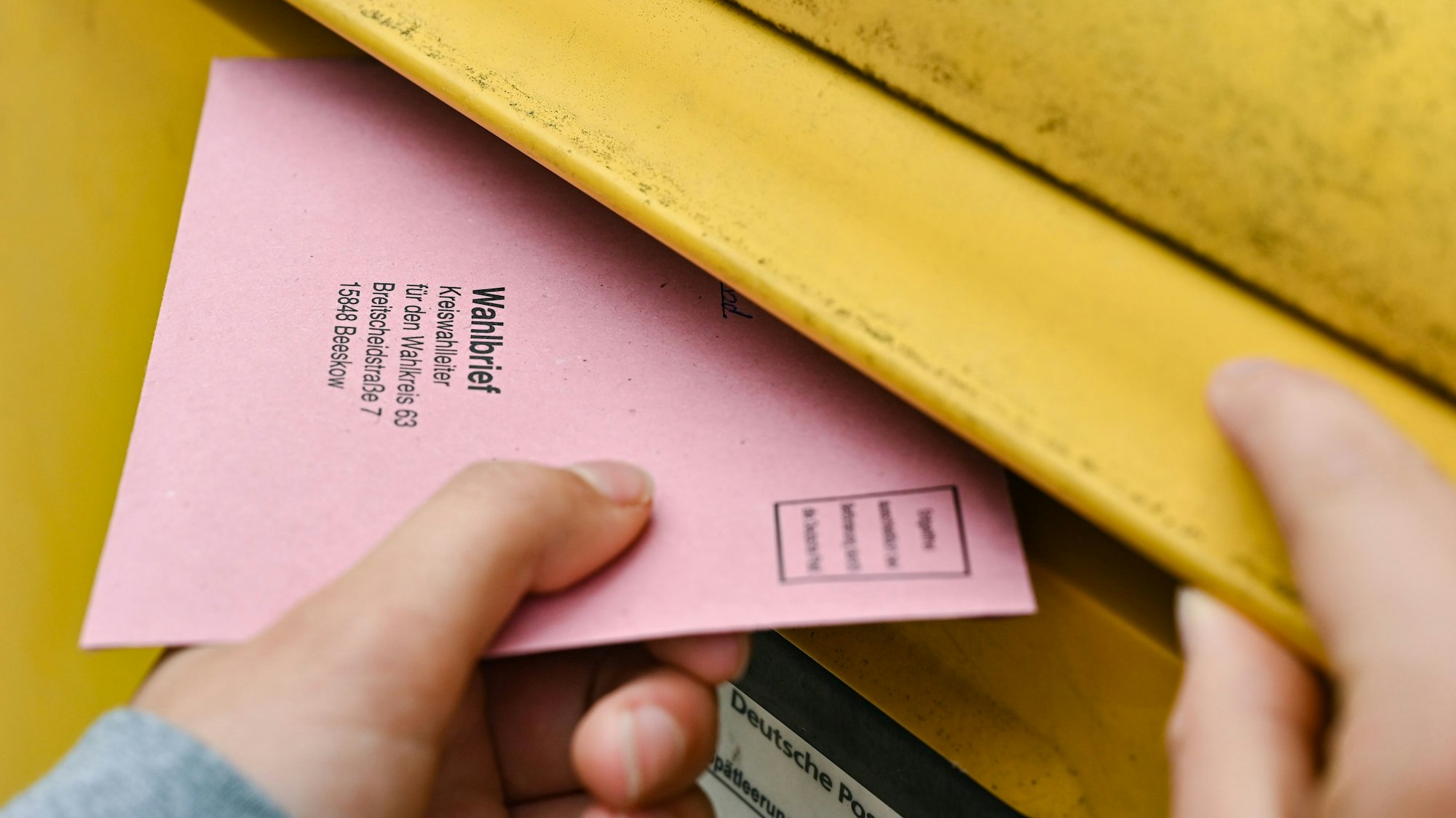 ARCHIV - 19.09.2021, Brandenburg, Sieversdorf: Eine Person wirft ihre Briefwahlunterlagen in einen Postkasten der Deutschen Post. (zu dpa: «Bundestags-Briefwahl: Post appelliert zum baldigen Einwurf») Foto: Patrick Pleul/dpa-Zentralbild/dpa +++ dpa-Bildfunk +++