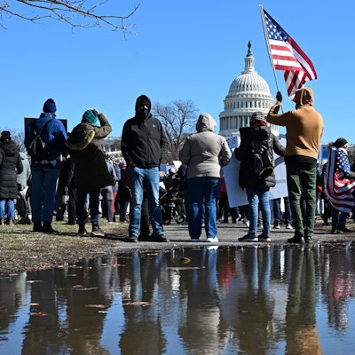 TOPSHOT - Demonstrators rally against US President Donald Trump and his policies during a protest near the US Capitol marking Presidents Day on February 17, 2025 in Washington, DC. (Photo by Alex Wroblewski / AFP)