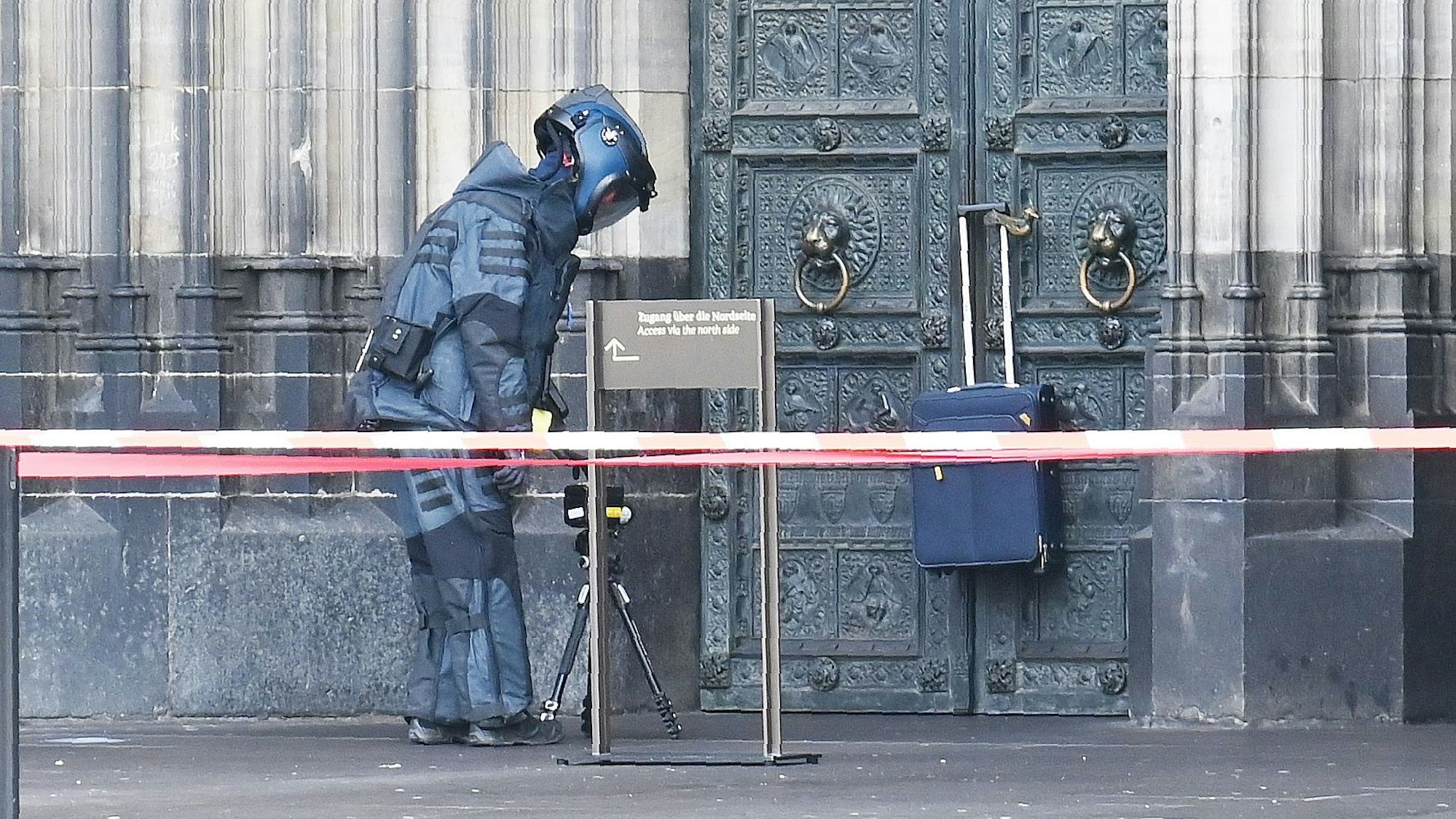Ein Entschärfer stellt ein mobiles Röntgengerät vor den Koffer auf.
