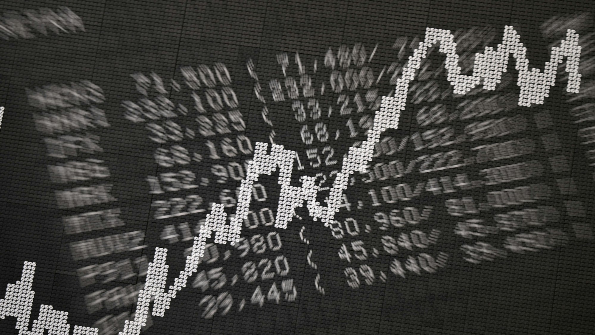 Die Doppelbelichtung zeigt eine Anzeigetafel im Handelssaal der Frankfurter Wertpapierbörse mit Kursen von Unternehmen im Xetra-Handel sowie der Dax-Kurve (Aufnahme mit Doppelbelichtung und Zoomeffekt).