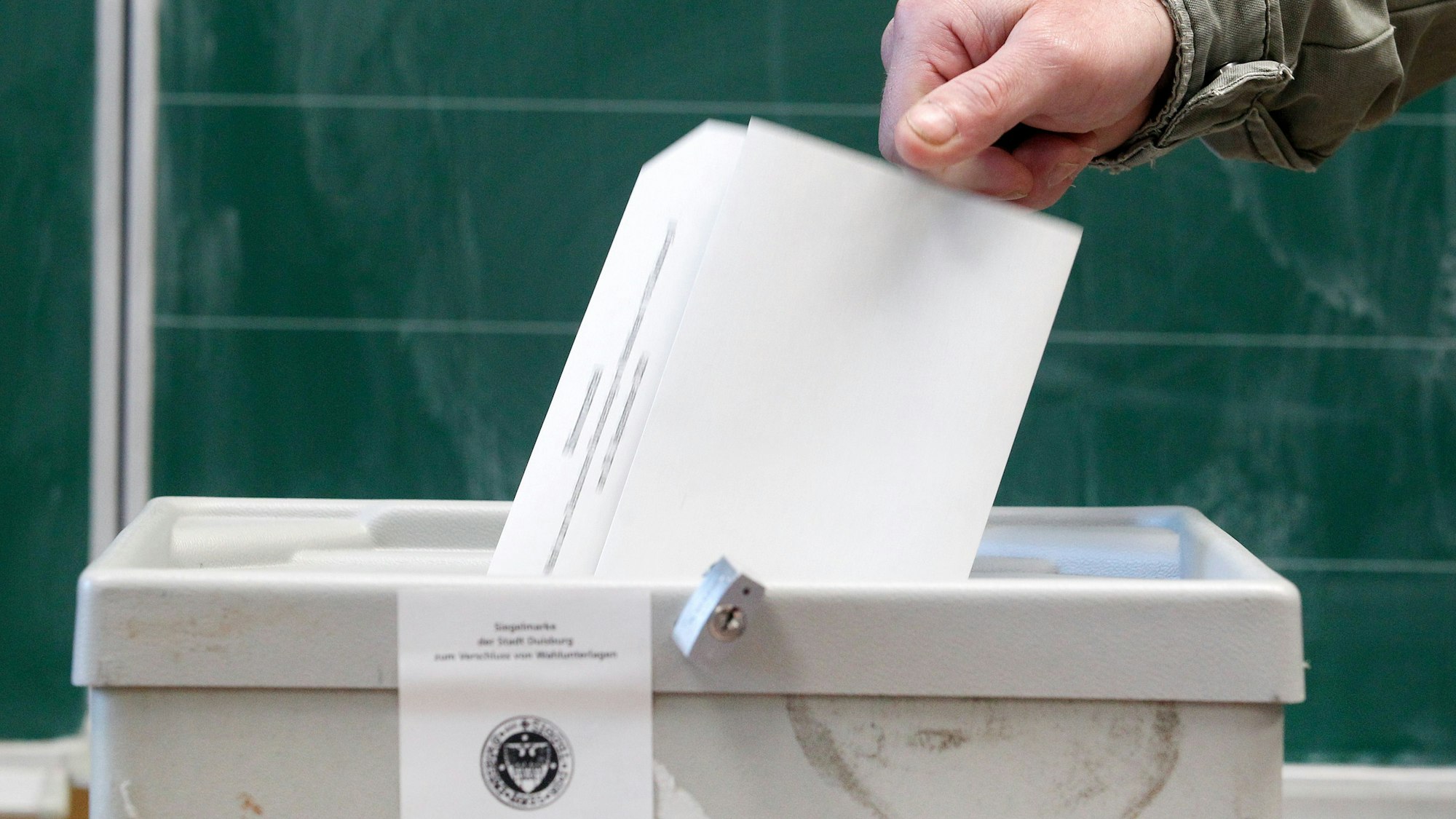 Ein Wähler wirft seinen Stimmzettel in einem Wahllokal in die Wahlurne.