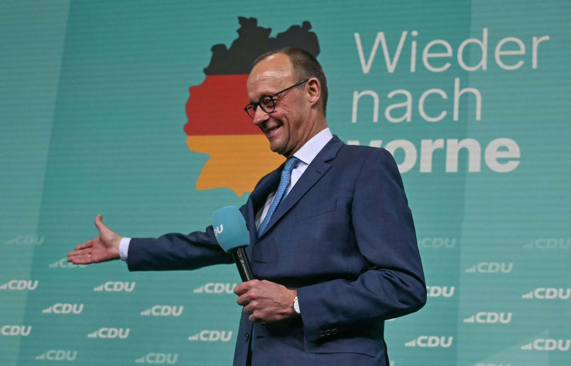 Friedrich Merz, leader of Germany's conservative Christian Democratic Union (CDU) and his party's main candidate for Chancellor addresses supporters after the first exit polls in the German general elections were announced on TV during the electoral evening in Berlin on February 23, 2025. (Photo by INA FASSBENDER / AFP)