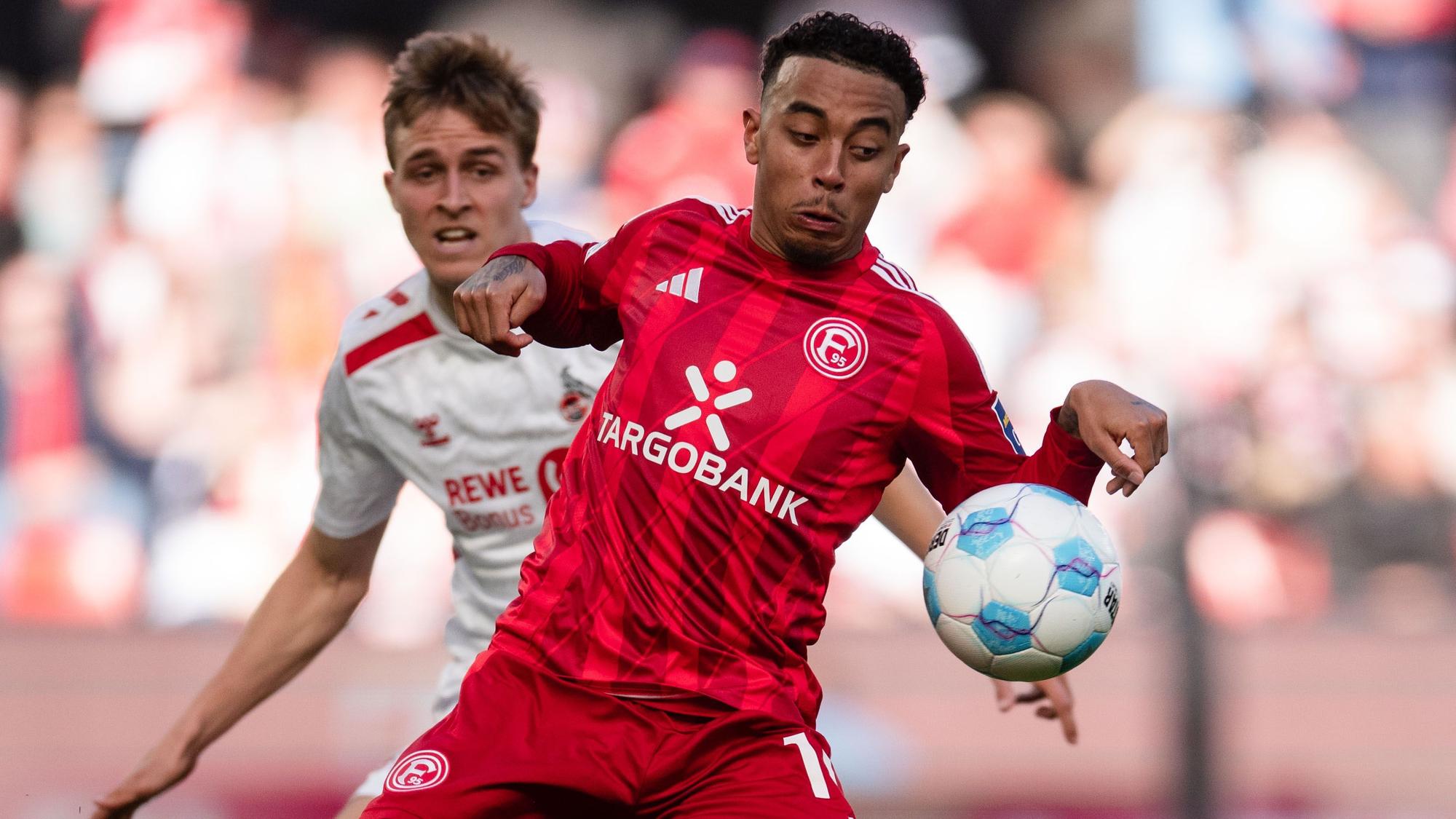 Timo Hübers (l) und Düsseldorfs Myron van Brederode kämpfen um den Ball.