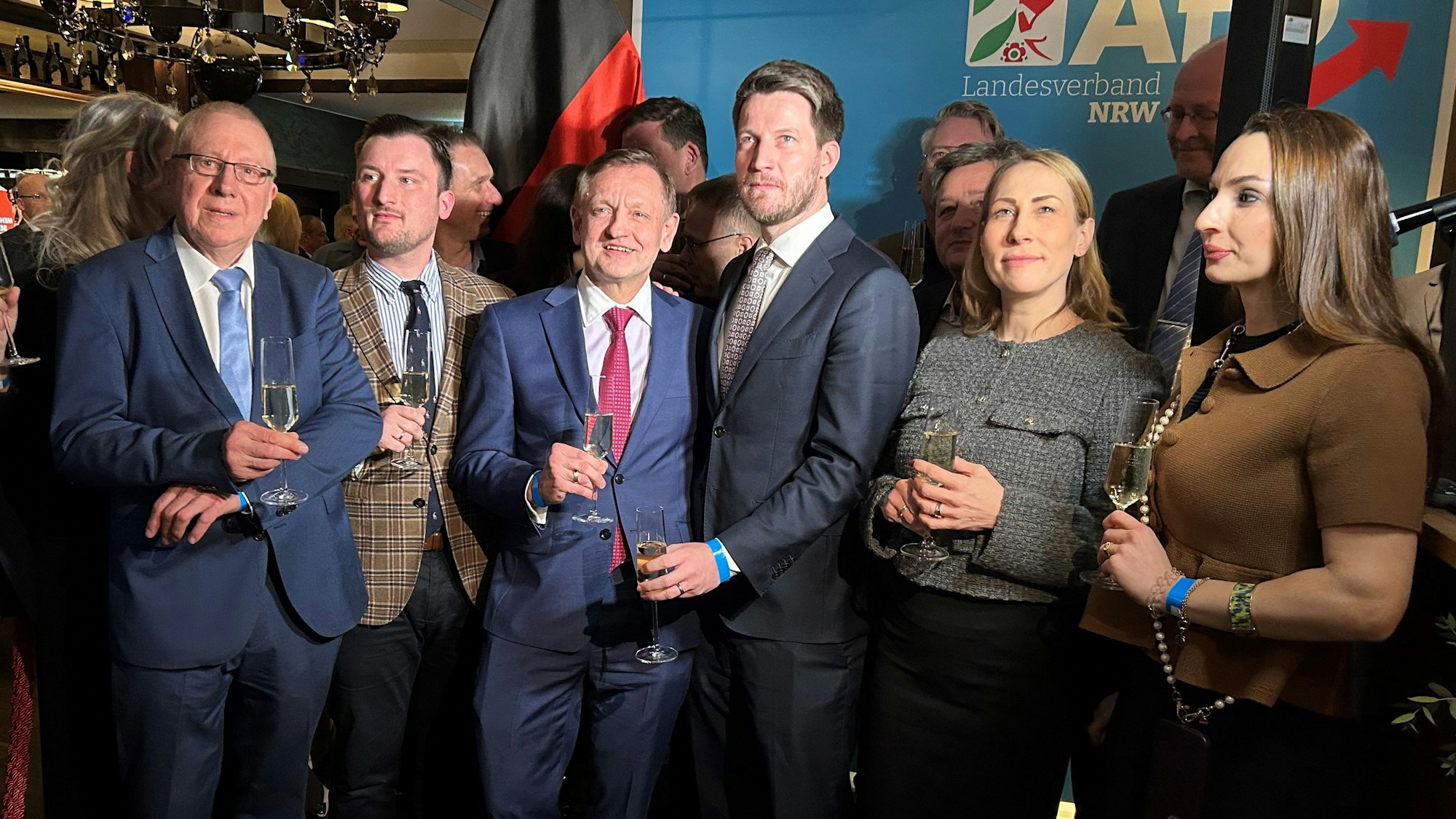 Eine Gruppe von Männern und zwei Frauen sind auf einem Gruppenbild bei der Wahlparty zu sehen.