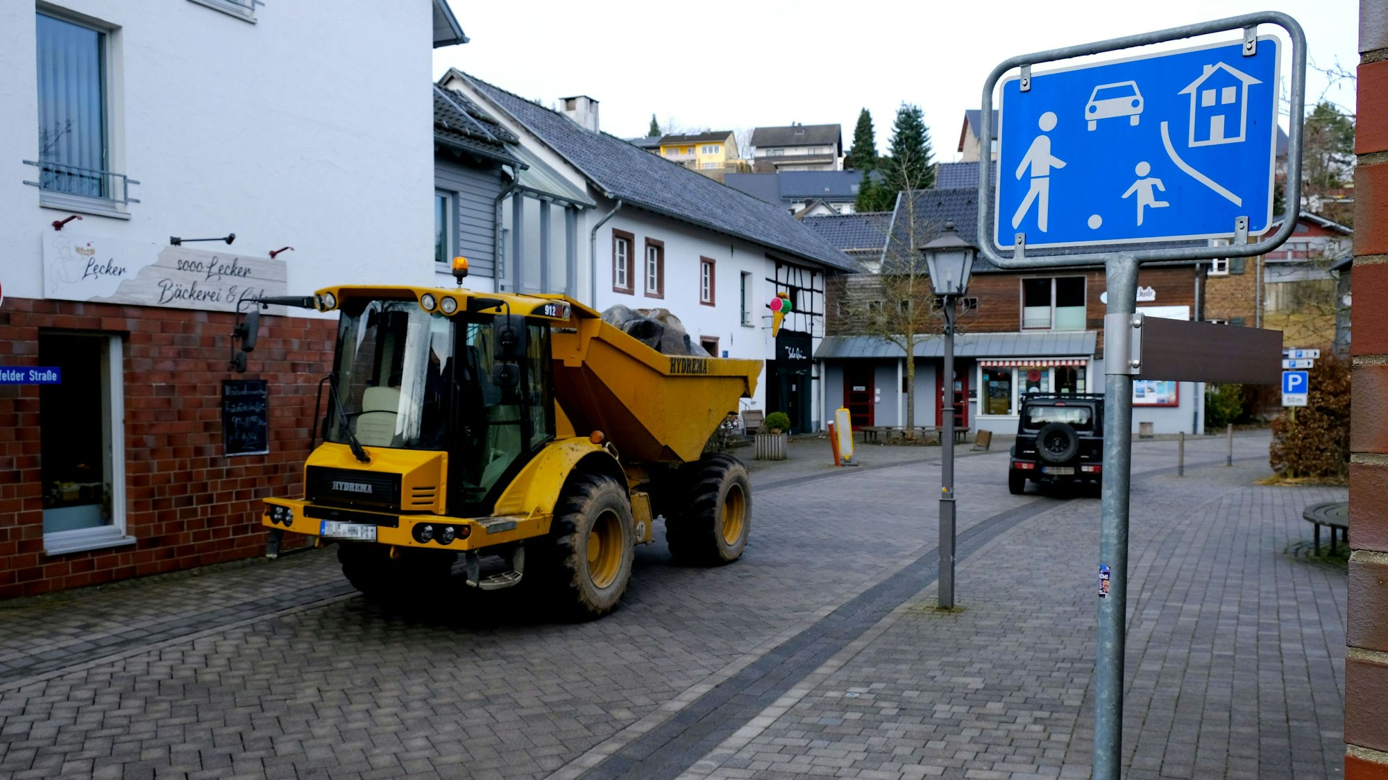 Ein schweres Baufahrzeug fährt durch die Spielstraße.