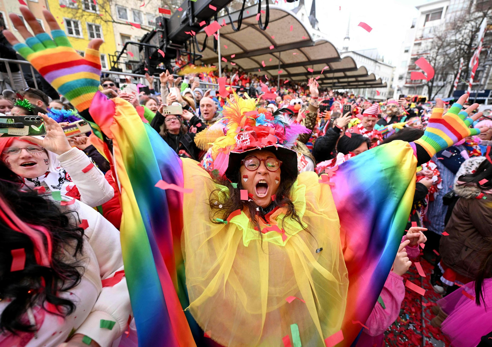 Carnivalists cheer during the launch of the hot carnival season in Cologne, western Germany, on February 27, 2025. (Photo by INA FASSBENDER / AFP)