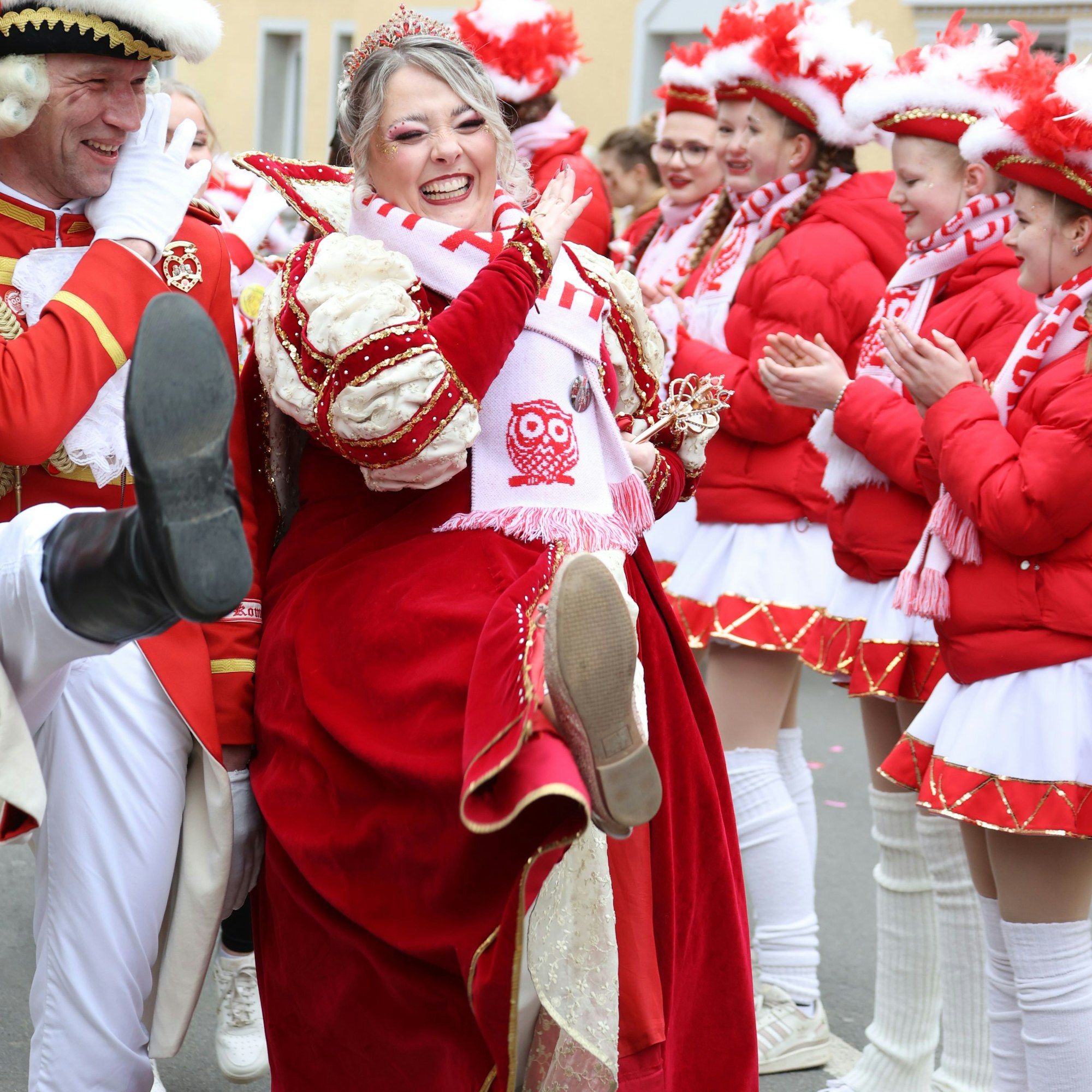 Lachend und im Stechschritt und neben sich einen männlichen Unterstützer geht die Prinzessin über die Straße.