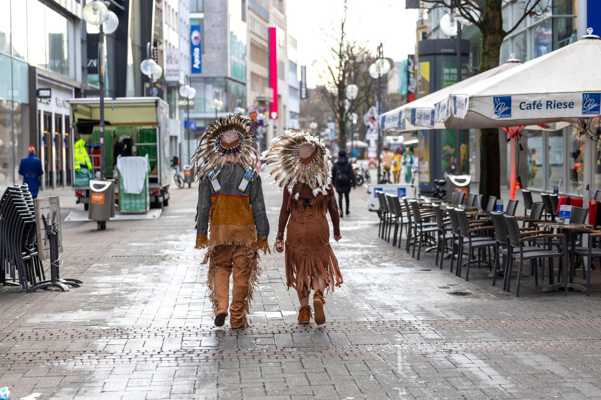 Zwei verkleidete Karnevalisten gehen durch die Innenstadt.