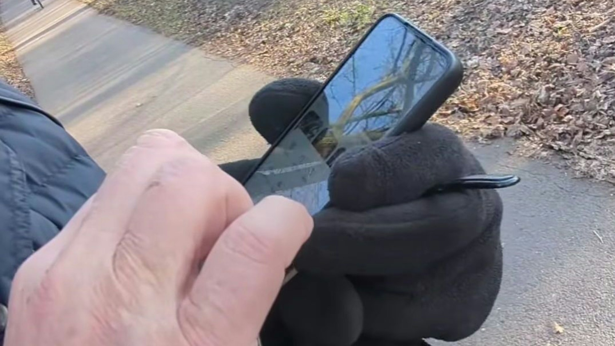 Der Fremde tippt auf seinem Handy, um das Video, das er von Yanni Gentsch gemacht hat, zu löschen.