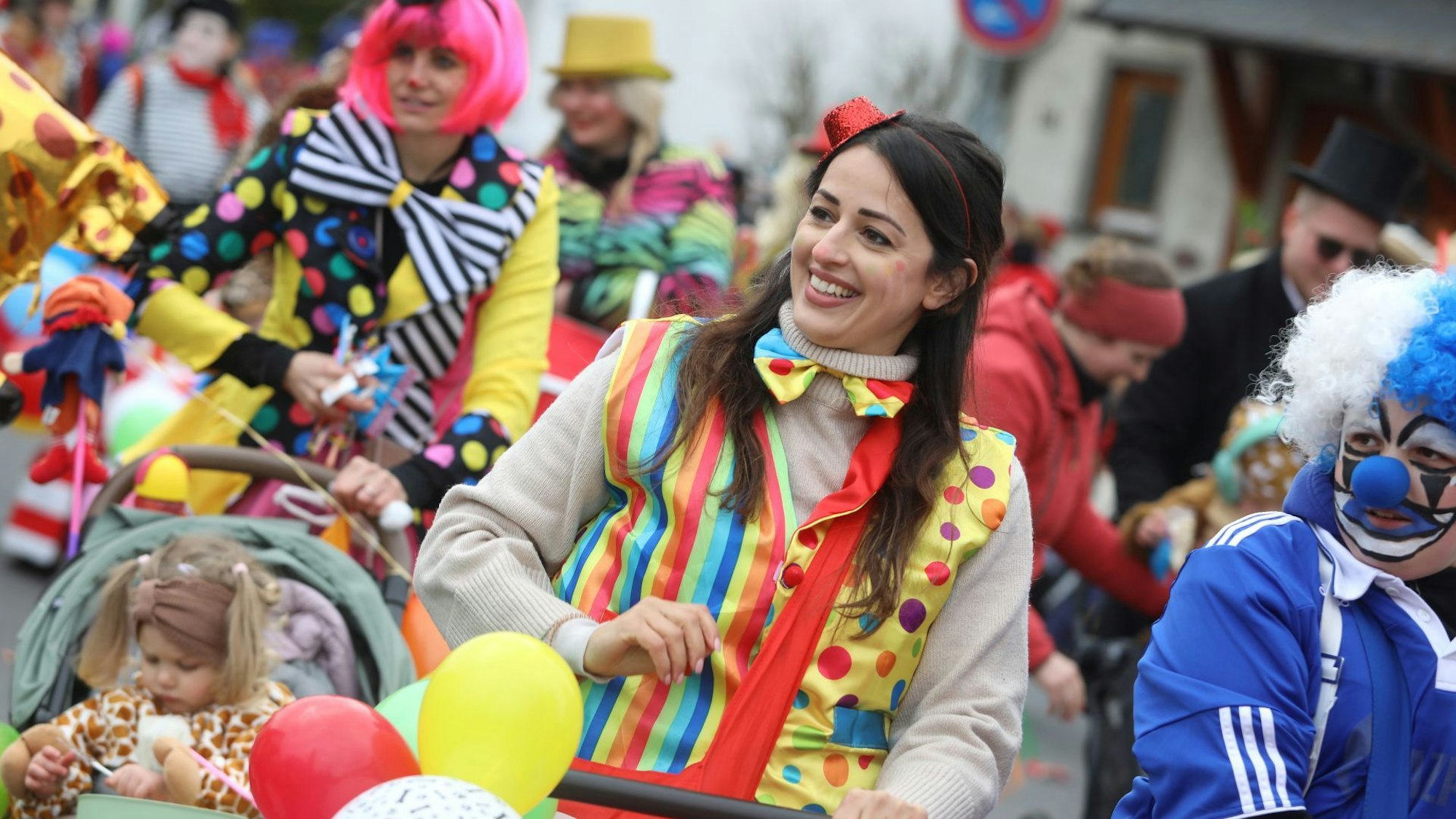 Bunt kostümierte Frauen mit Kindern
