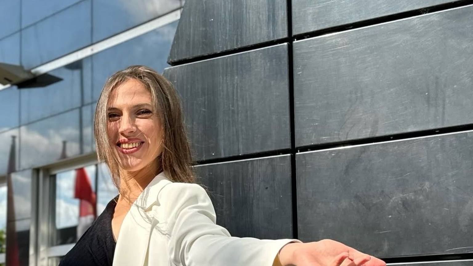 Auf dem Foto ist eine junge Frau mit langem braunen Haar zu sehen.