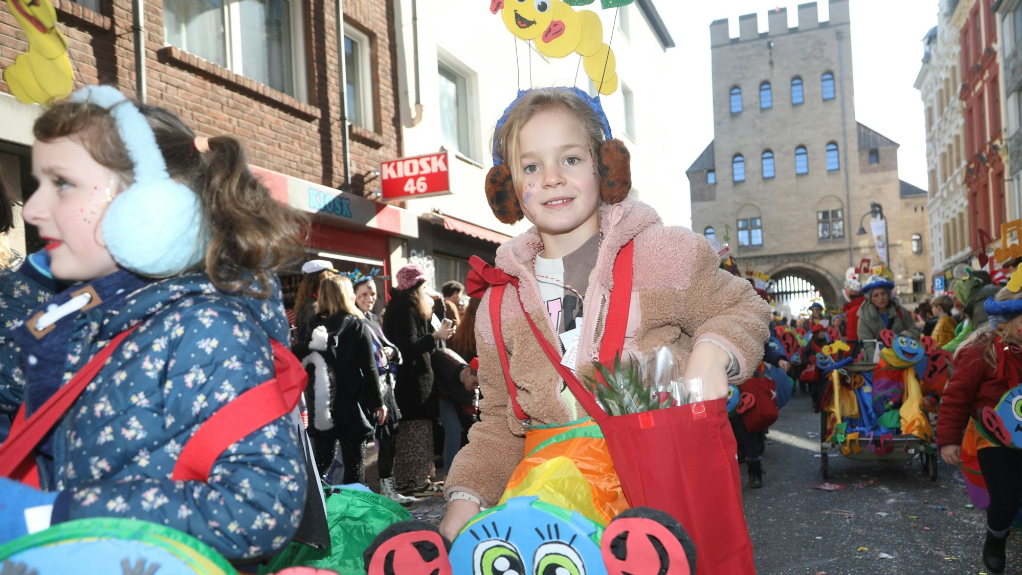 Kinder verteilen und erhalten Kamelle. Die Schull- un Veedelszöch sind eine feste Größe im Kölner Karneval.