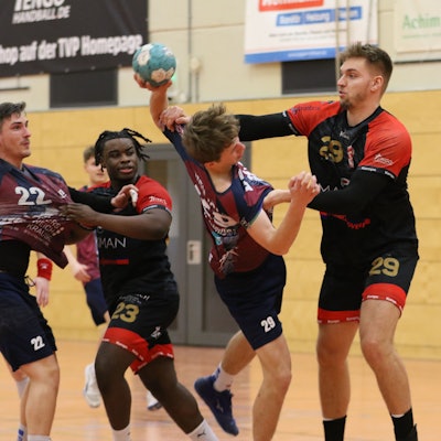 Palmersheims Robin Voiß greift mit beiden Armen den ballführenden Gegner an. Eine Hand geht an den Oberarm, die andere an die Brust. Ein Mitspieler und ein Gegenspieler schauen zu.