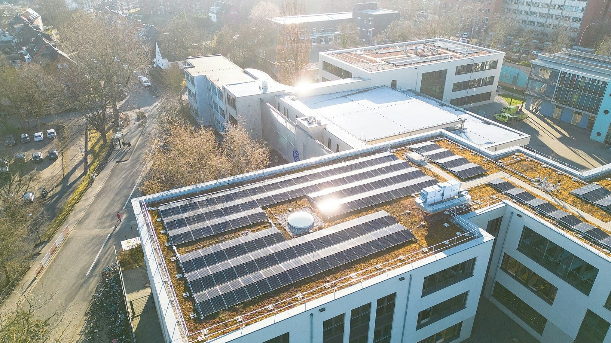 Die Luftaufnahme zeigt die Solarmodule auf den Dächern der Neubauten am Ernst-Mach-Gymnasium.
