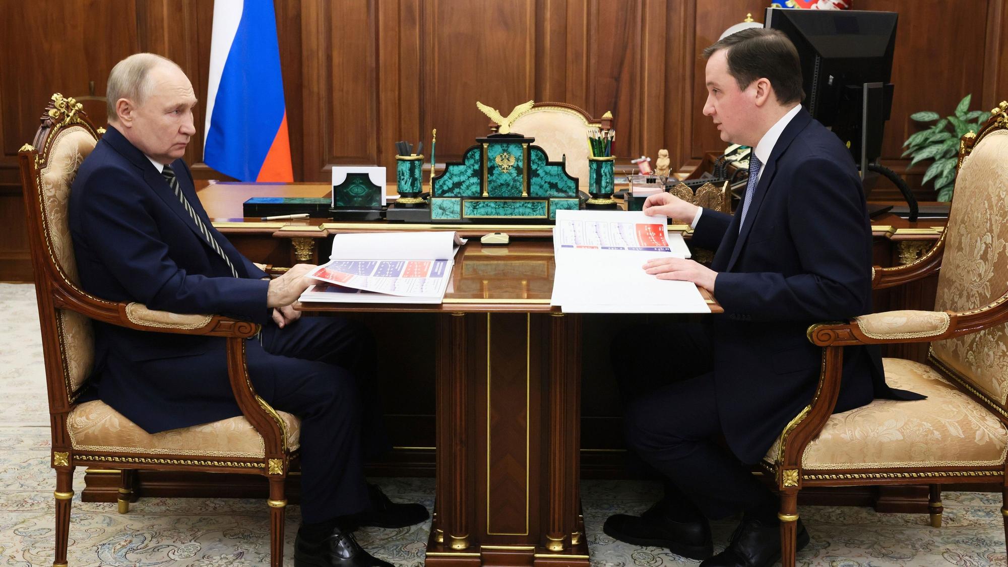 11.03.2025, Russland, Moskau: Der russische Präsident Wladimir Putin (l) spricht mit dem Gouverneur der Region Archangelsk Alexander Tsybulsky während ihres Treffens im Kreml.