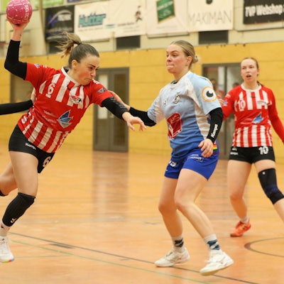 Svenja Bank stürmt mit dem Ball in der Hand Richtung Tor. Zwei Gegenspielerinnen sind an ihr dran, können sie aber nicht stoppen.