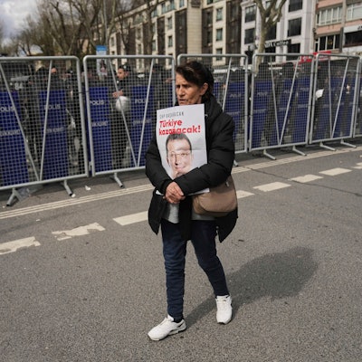 Eine Frau protestiert mit einem Plakat, das den Istanbuler Bürgermeister Ekrem Imamoglu zeigt vor einem Polizeiaufgebot in Istanbul