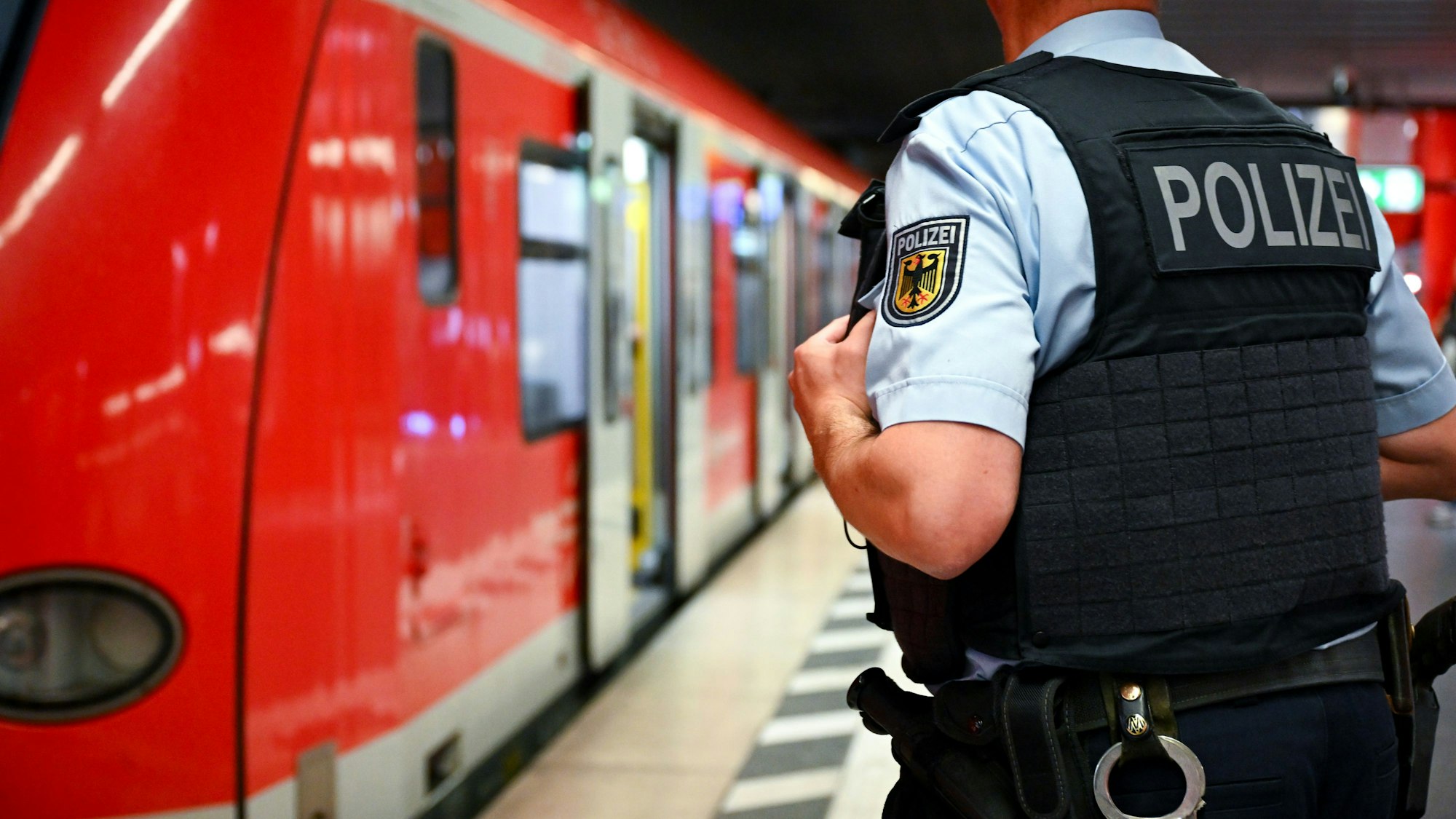 Ein Bundespolizist steht am Hauptbahnhof München an einer S-Bahn. (Symbolbild)