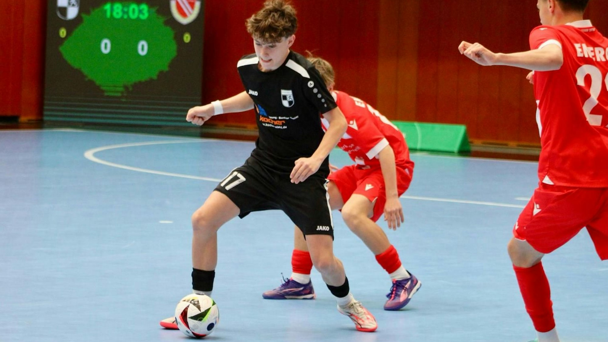 Rafael Baum mit dem Ball am Fuß wird von zwei Cottbuser Spielern angegriffen.