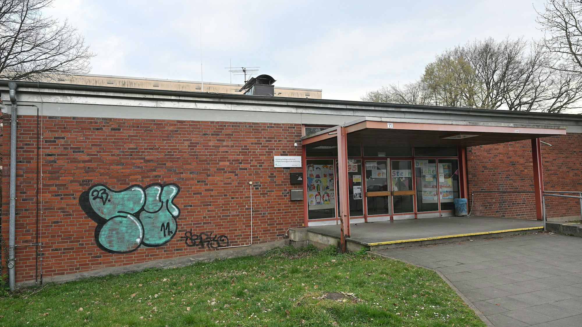 Man sieht den Eingang des einstöckigen Schulgebäudes.